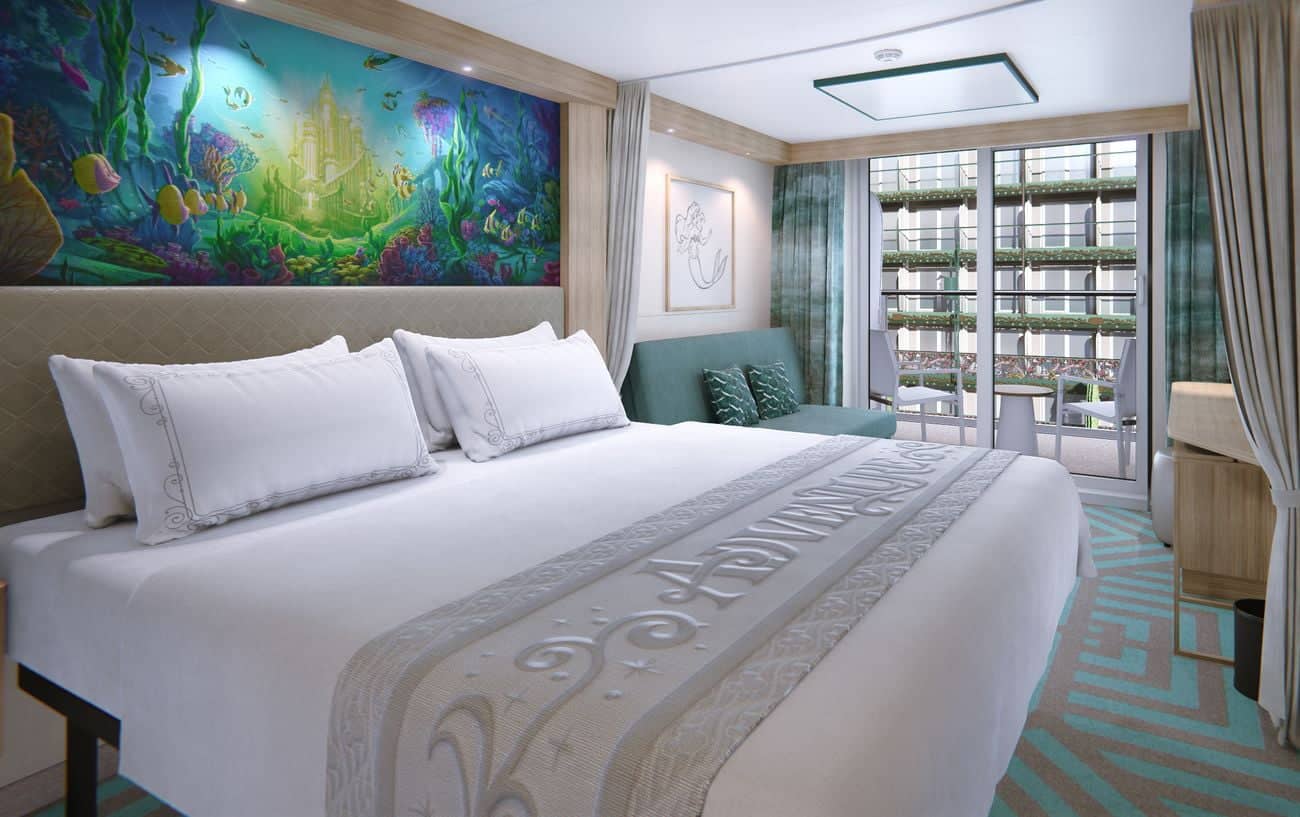 CGI stateroom featuring a king bed ocean-inspired artwork a sofa and balcony with garden-style views