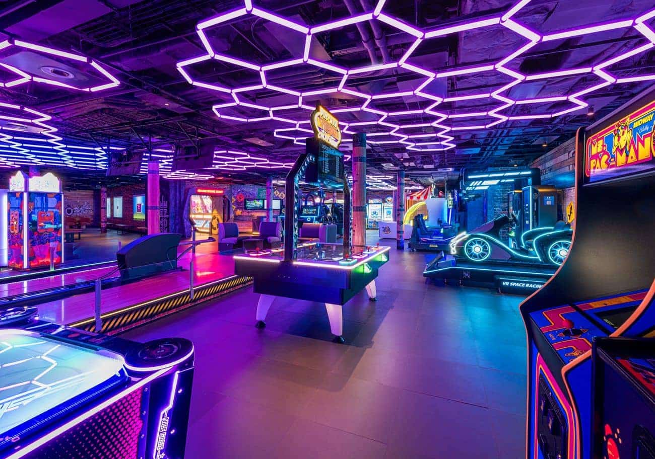 Interactive gaming area onboard Norwegian Aqua with neon lighting