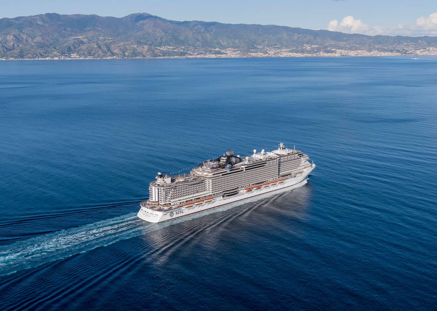 MSC Seaview sailing near a Mediterranean coastline