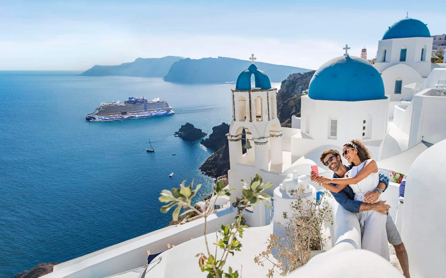 Norwegian Cruise Line ship near Santorini blue domes