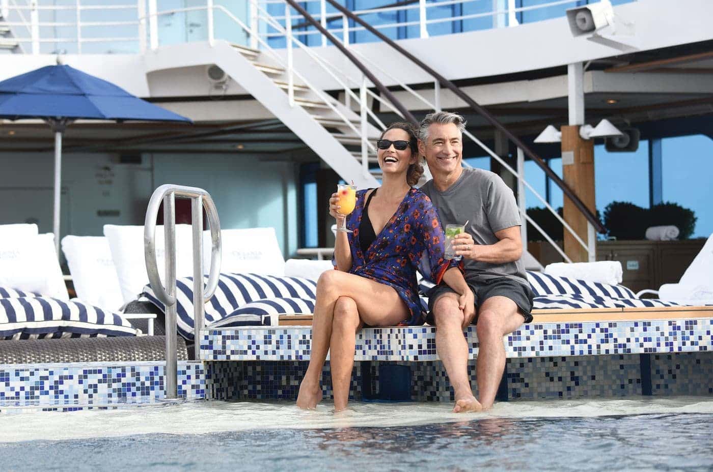 Couple relaxing by Regatta’s pool deck