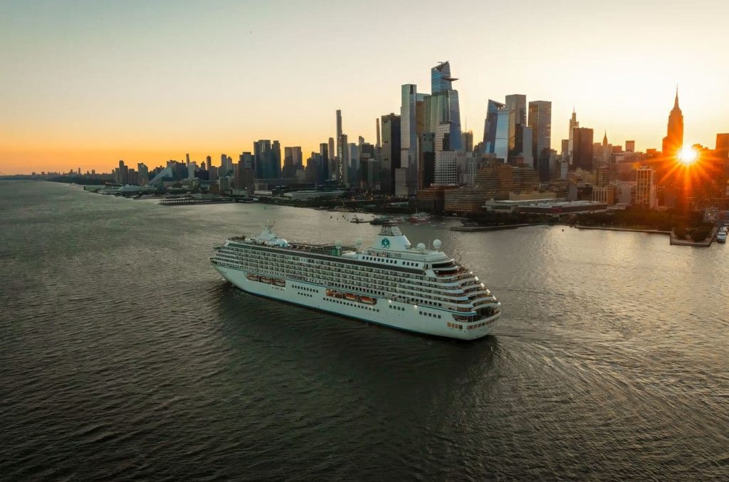 Crystal Serenity arriving in New York at sunrise with the city skyline in the background