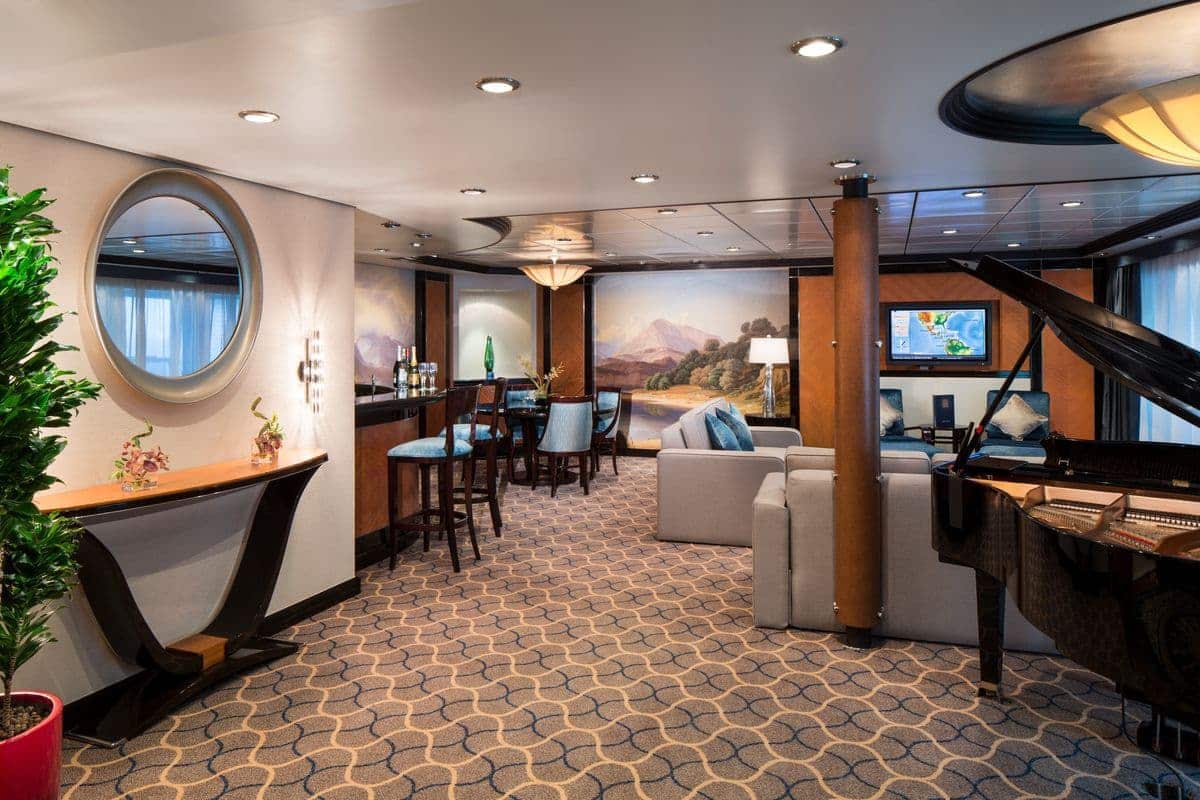 Royal Suite living area aboard Liberty of the Seas with piano and bar