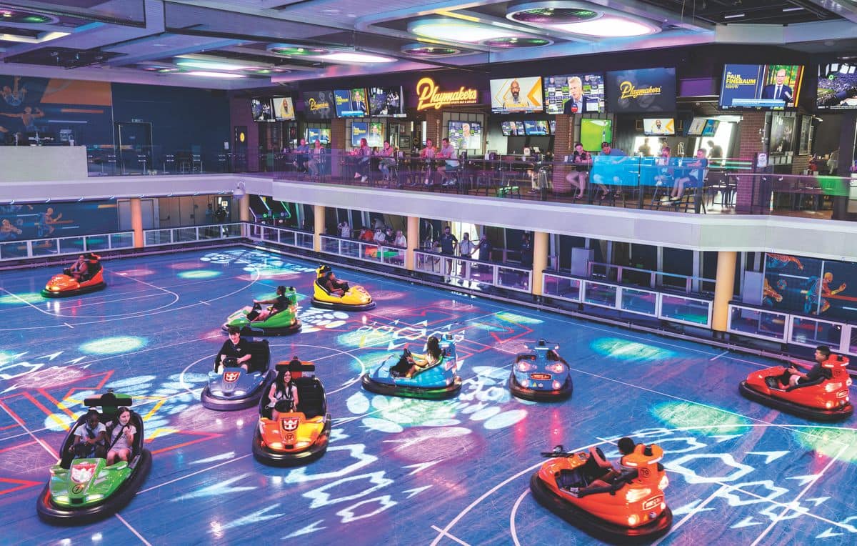 Seaplex entertainment complex on Odyssey of the Seas with bumper cars under neon lights and Playmakers Sports Bar above
