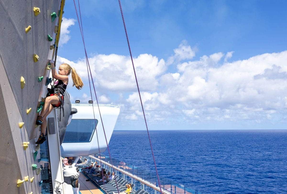 Young girl climbing the rock wall on Royal Caribbean’s Ovation of the Seas