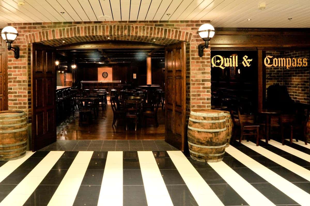 Quill & Compass Pub featuring brick arches and wooden décor