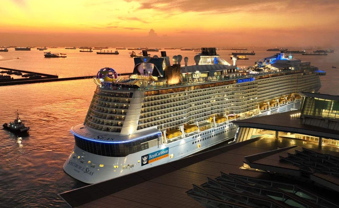 Spectrum of the Seas docked in Singapore at sunset with city skyline in the background
