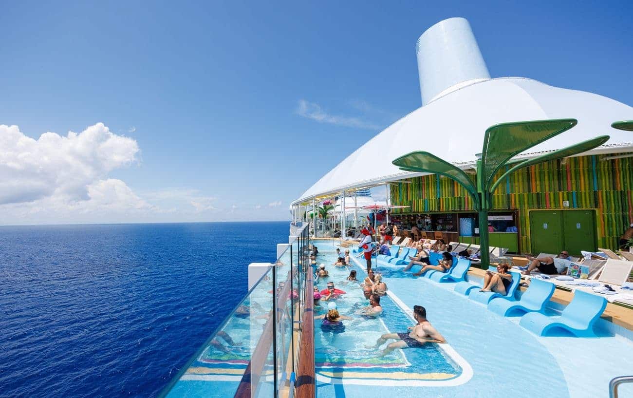 Cloud 17 pool deck overlooking the ocean with guests relaxing in the water