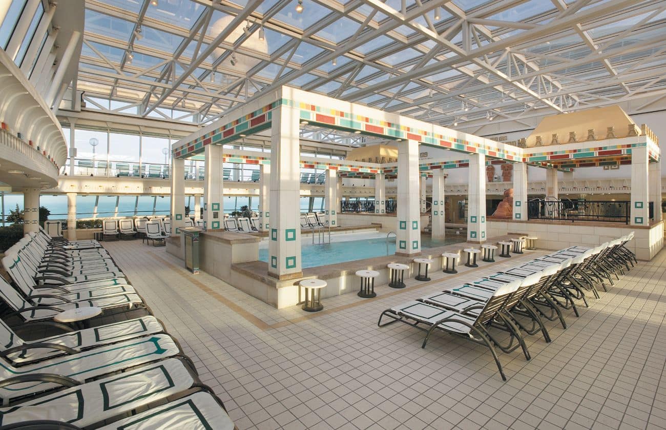 Solarium on Vision of the Seas with glass roof and poolside loungers