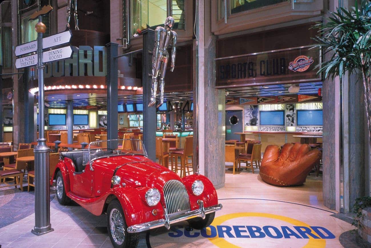 Scoreboard sports lounge on Voyager of the Seas with vintage car display