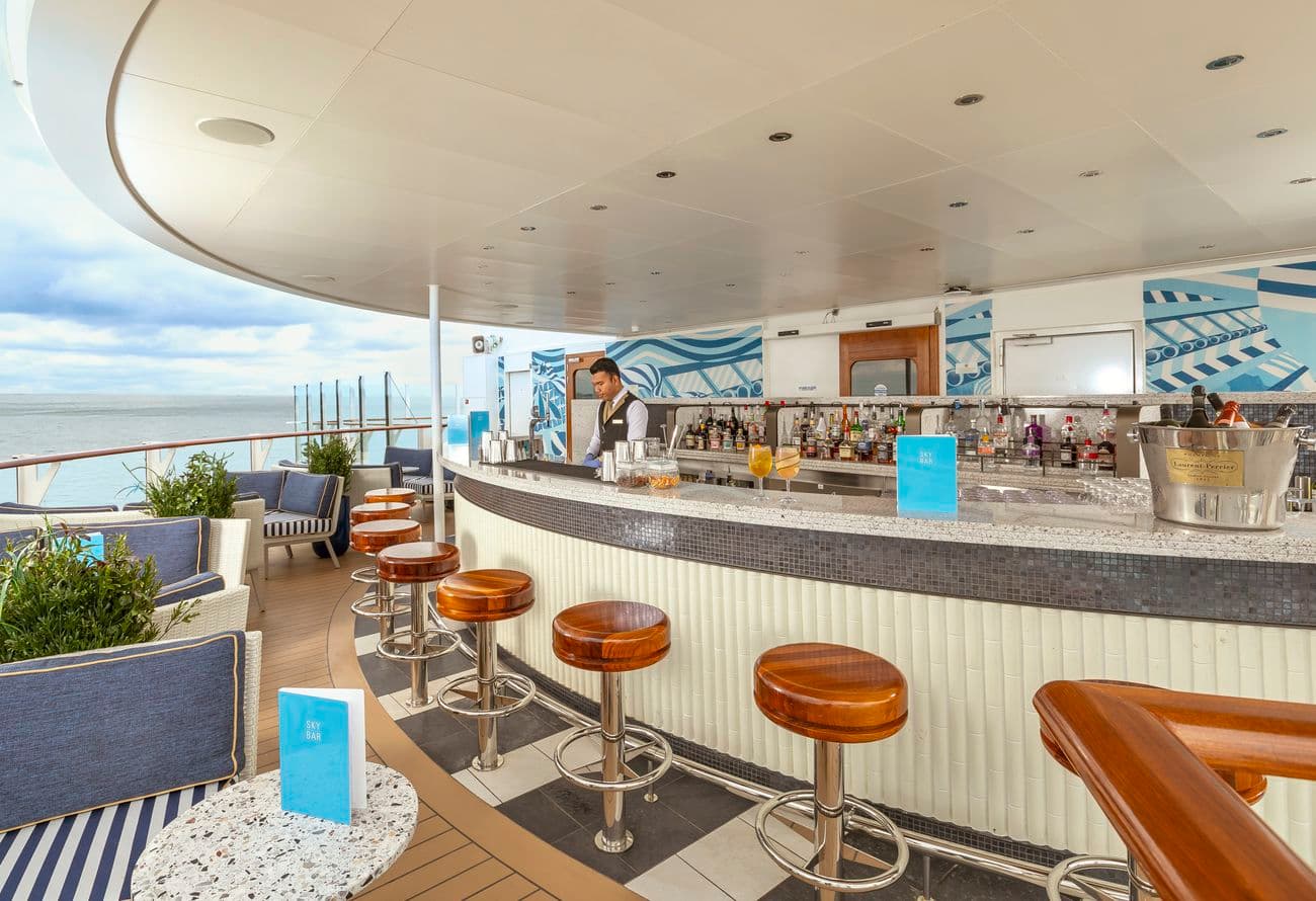 Sky Bar aboard Queen Anne with ocean-view seating and cocktail service