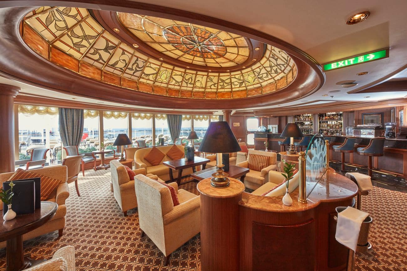 Grills Lounge on Queen Victoria with Art Deco ceiling and plush seating