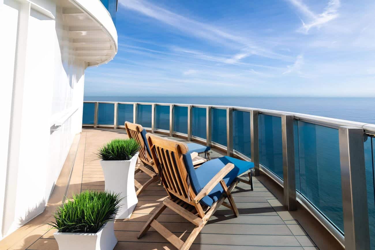 Spacious Penthouse Suite balcony with lounge chairs and ocean views