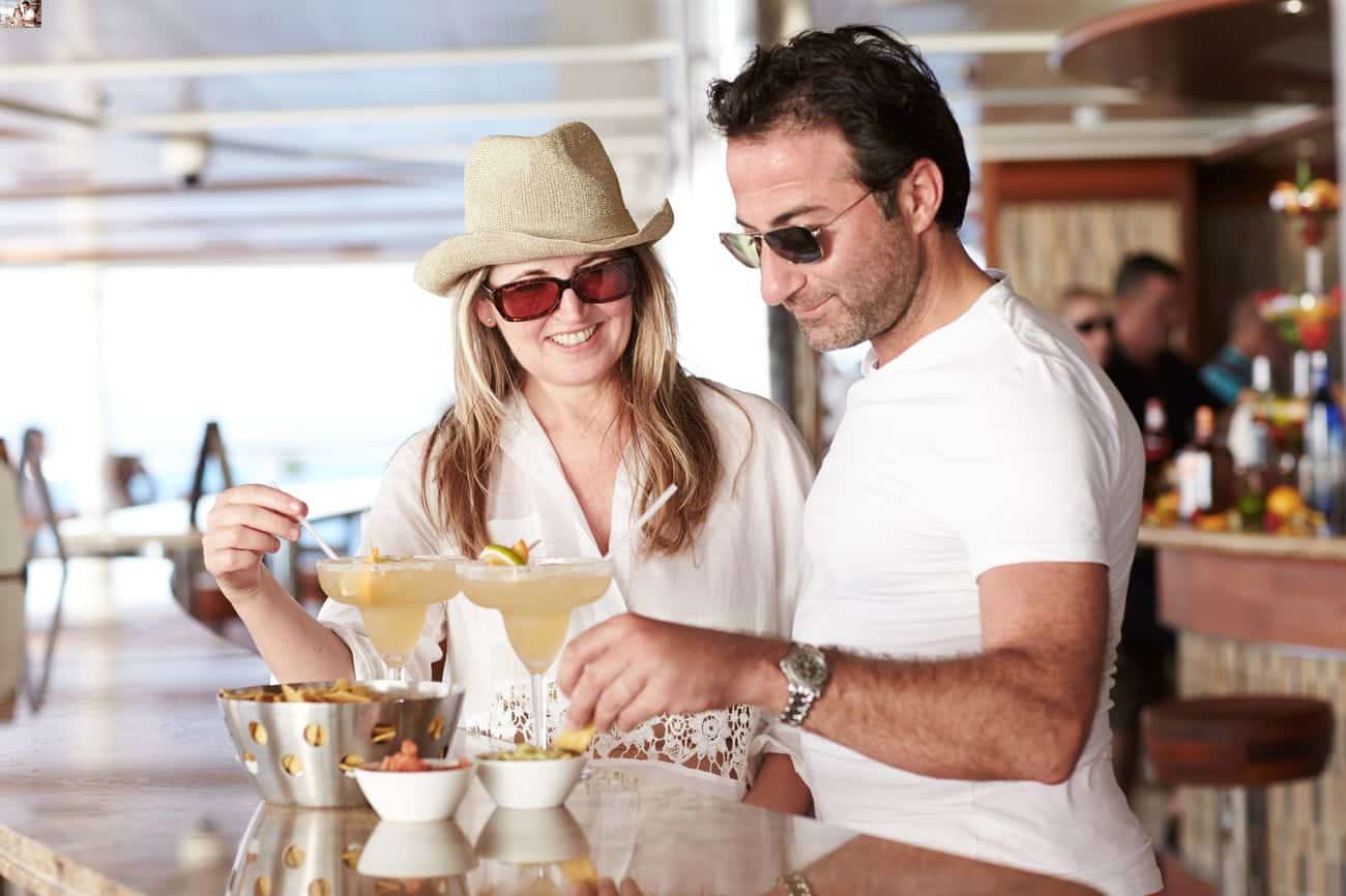 Couple enjoying margaritas at an outdoor bar
