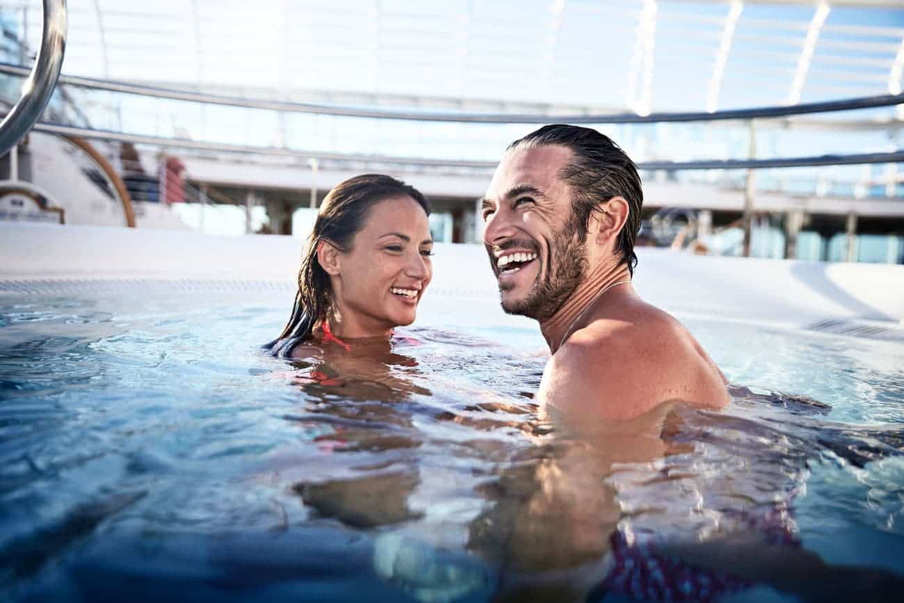 Couple enjoying the hot tub under the ship’s glass canopy