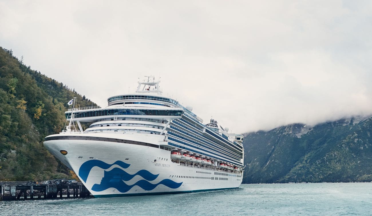 Ruby Princess docked in Skagway, Alaska surrounded by forested mountains and mist