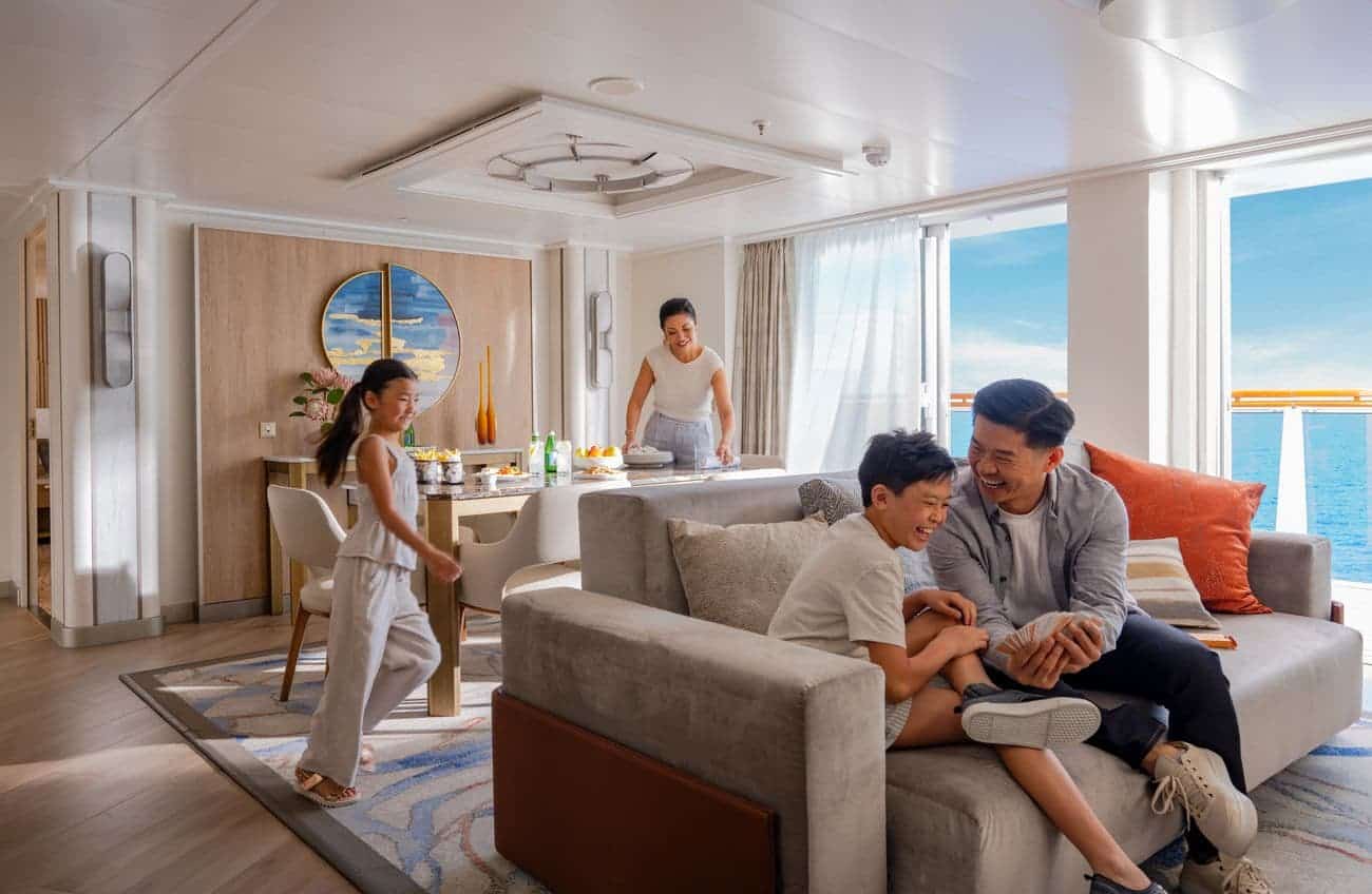 Family enjoying the spacious Sky Suite living room on Star Princess with ocean views