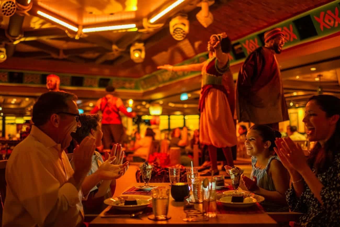 Guests enjoying an immersive Lion King themed dining experience with performers entertaining tableside