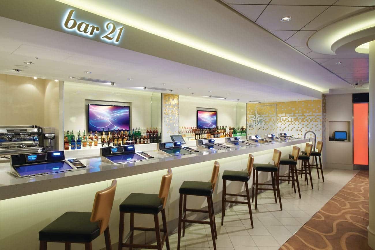 Bar 21 lounge featuring a long illuminated bar with modern seating and digital displays