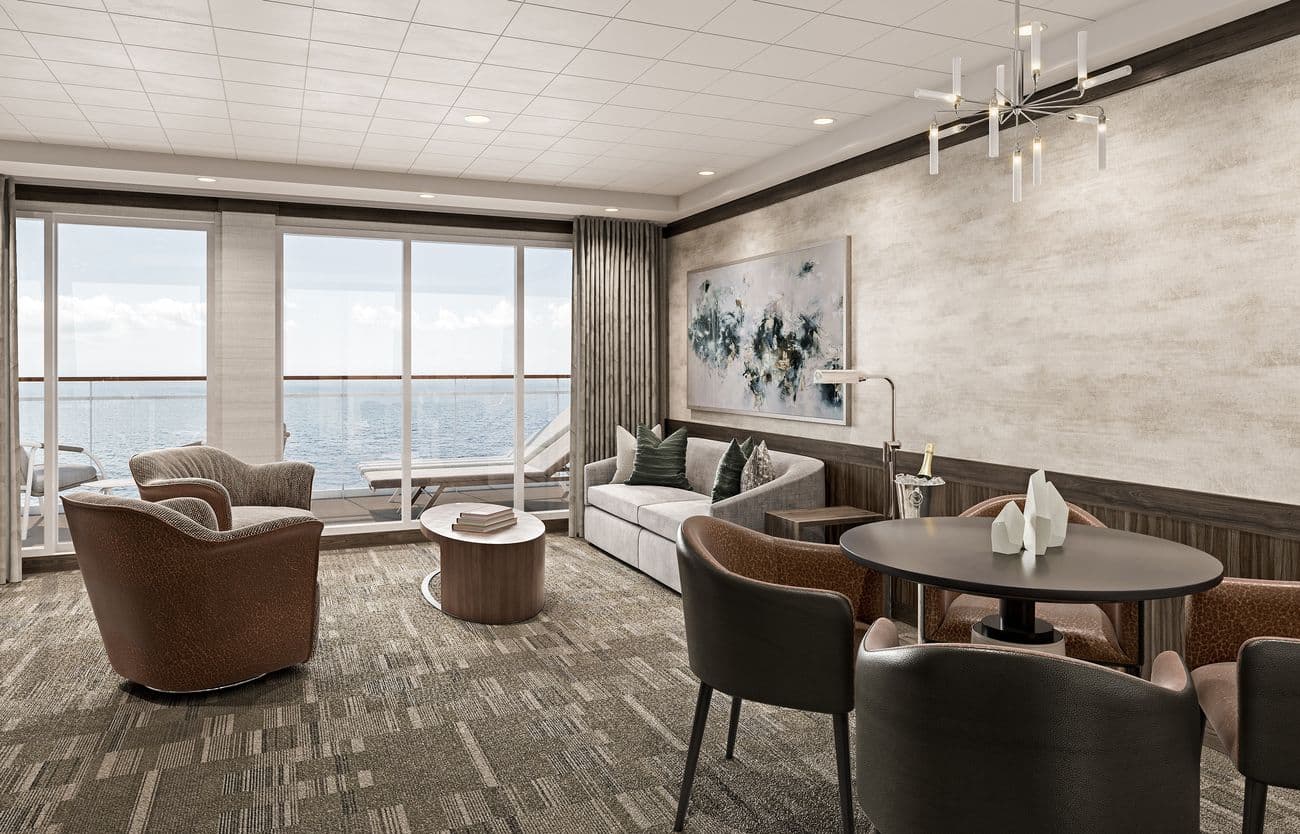 Owner’s Suite living room on Norwegian Epic with ocean-view balcony and contemporary furnishings
