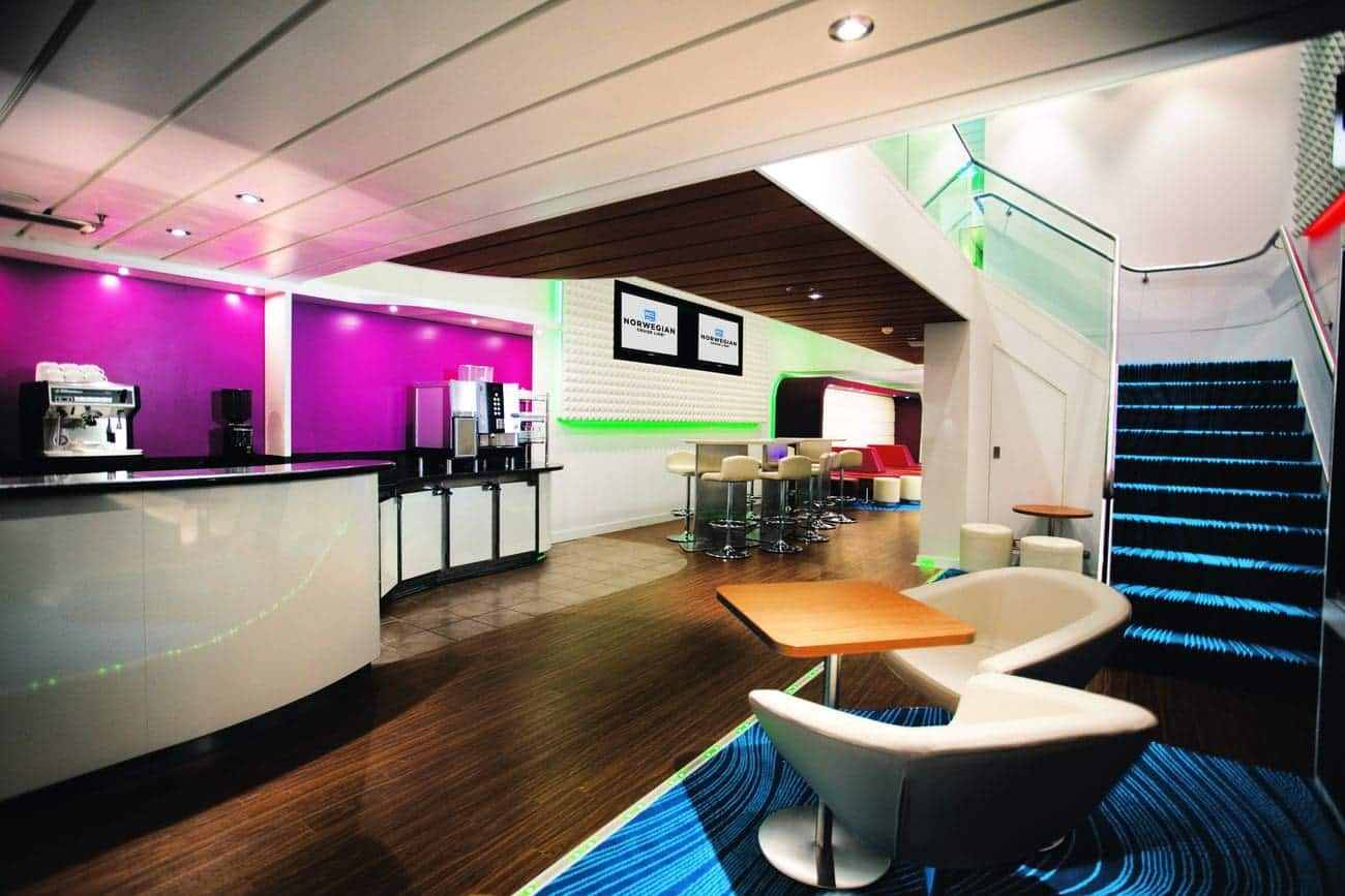 Studio Lounge on Norwegian Epic with bar seating, colorful lighting, and modern social spaces
