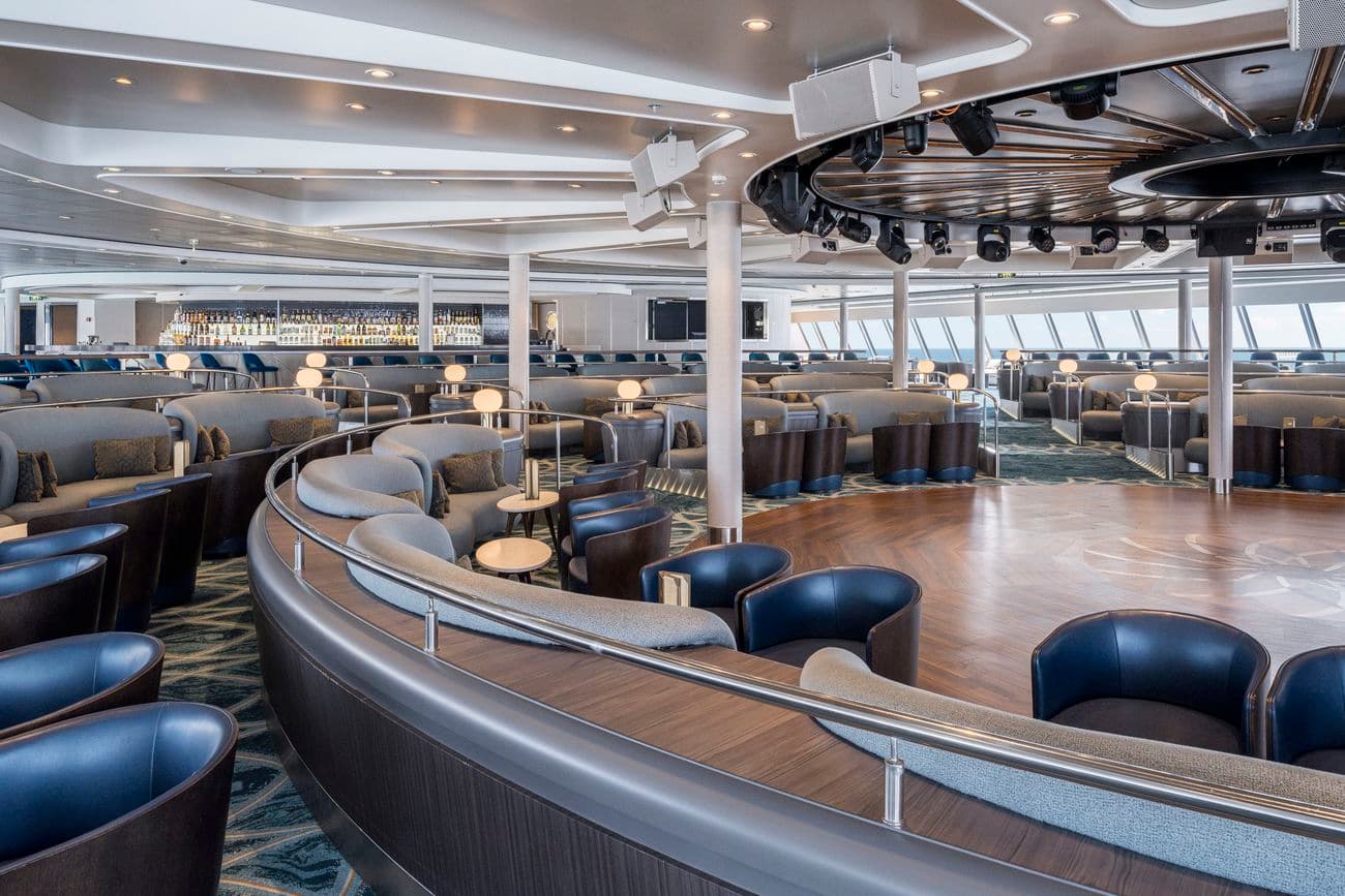 Spinnaker Lounge on Norwegian Gem with curved seating, dance floor, and forward facing windows