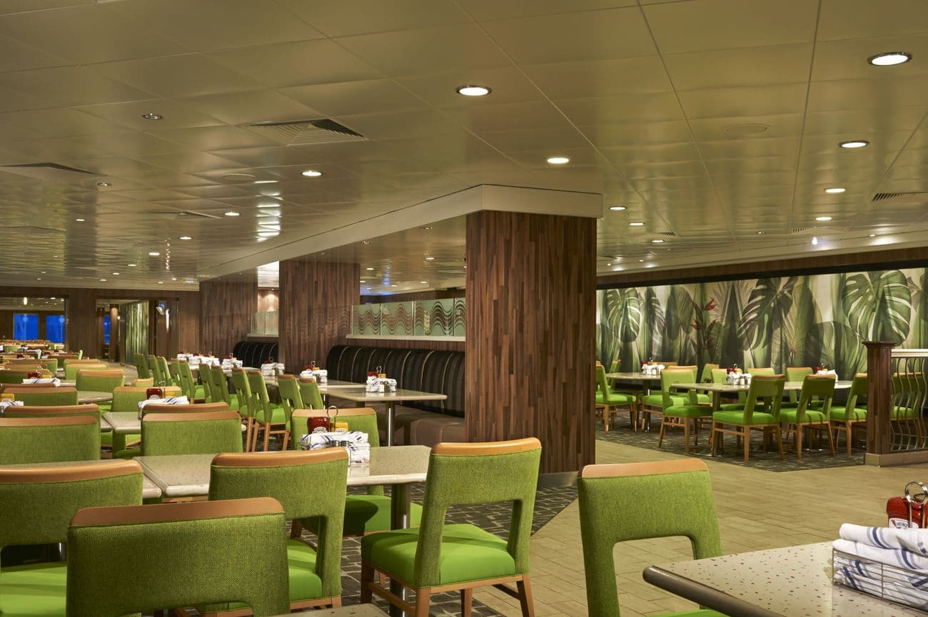 Garden Café buffet restaurant with green chairs, tropical wall décor, and spacious dining layout