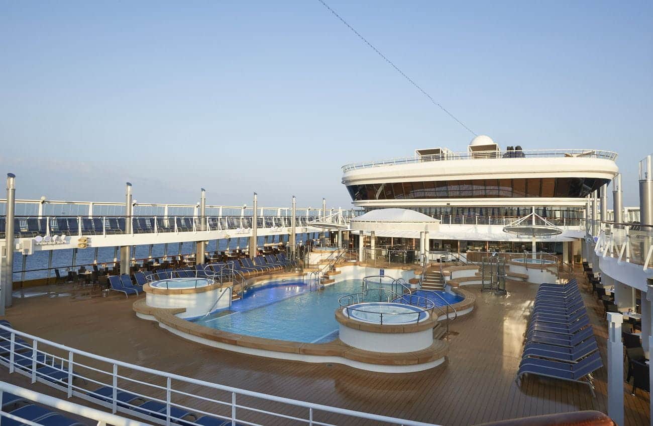 Pool deck on Norwegian Star with swimming pools, whirlpools, sun loungers, and ocean views