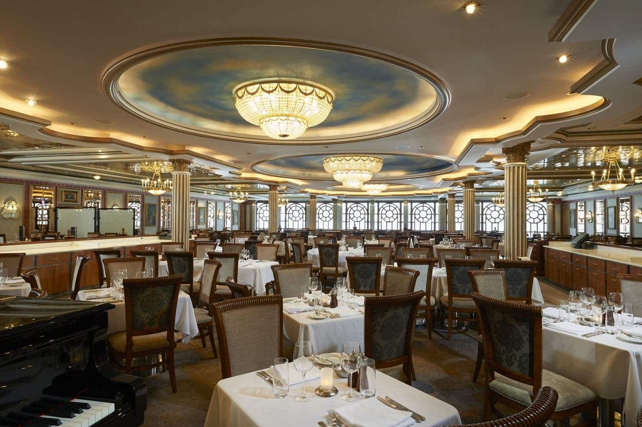 Versailles Dining Room with elegant chandeliers, white tablecloths, and formal seating