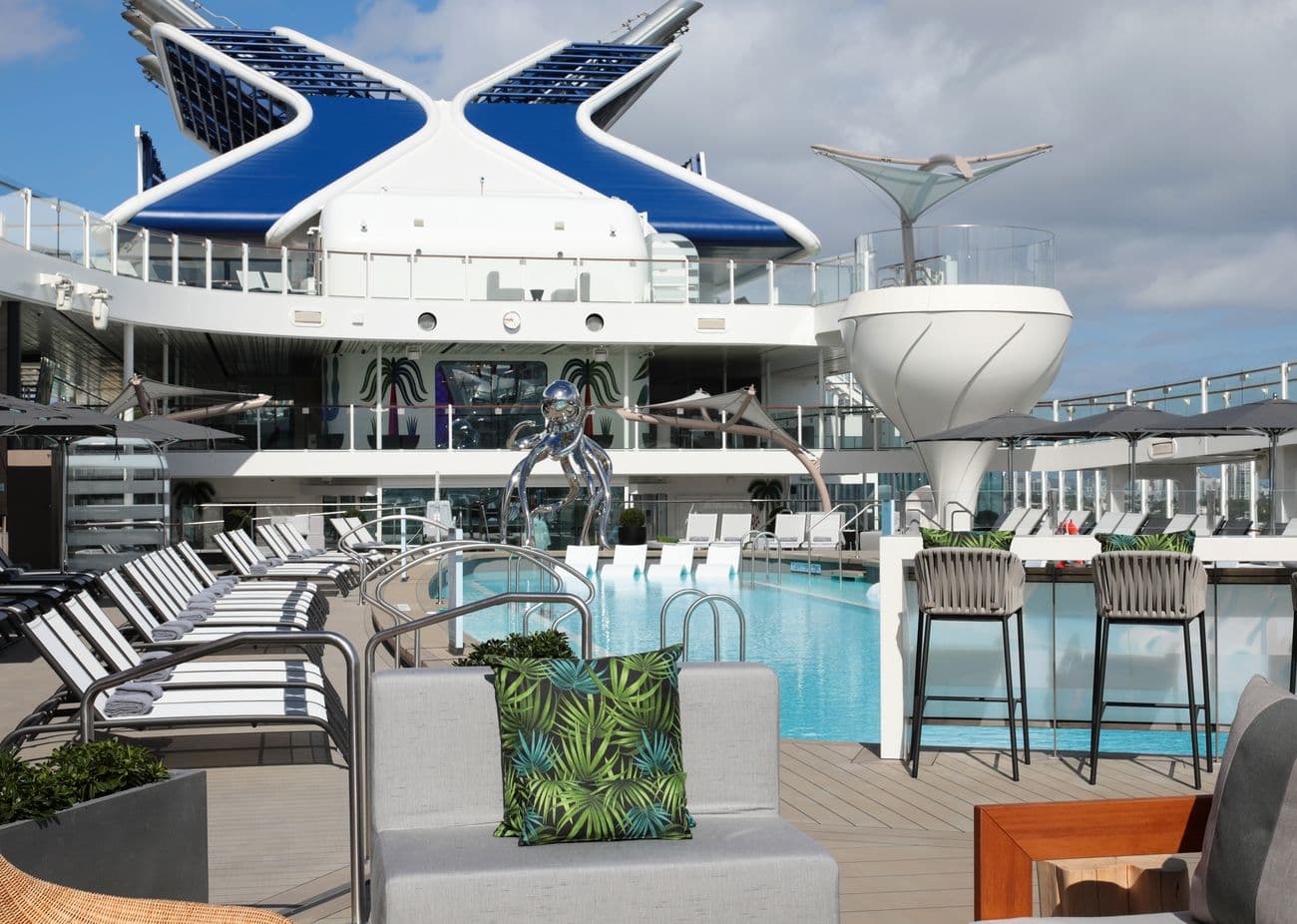 Celebrity Ascent resort deck pool area with sun loungers and bar seating