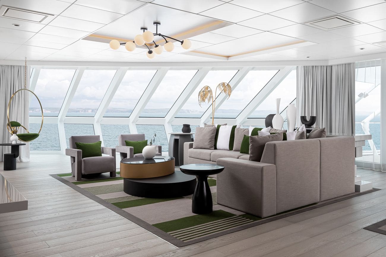 Iconic Suite living area on Celebrity Beyond with floor-to-ceiling windows and ocean views