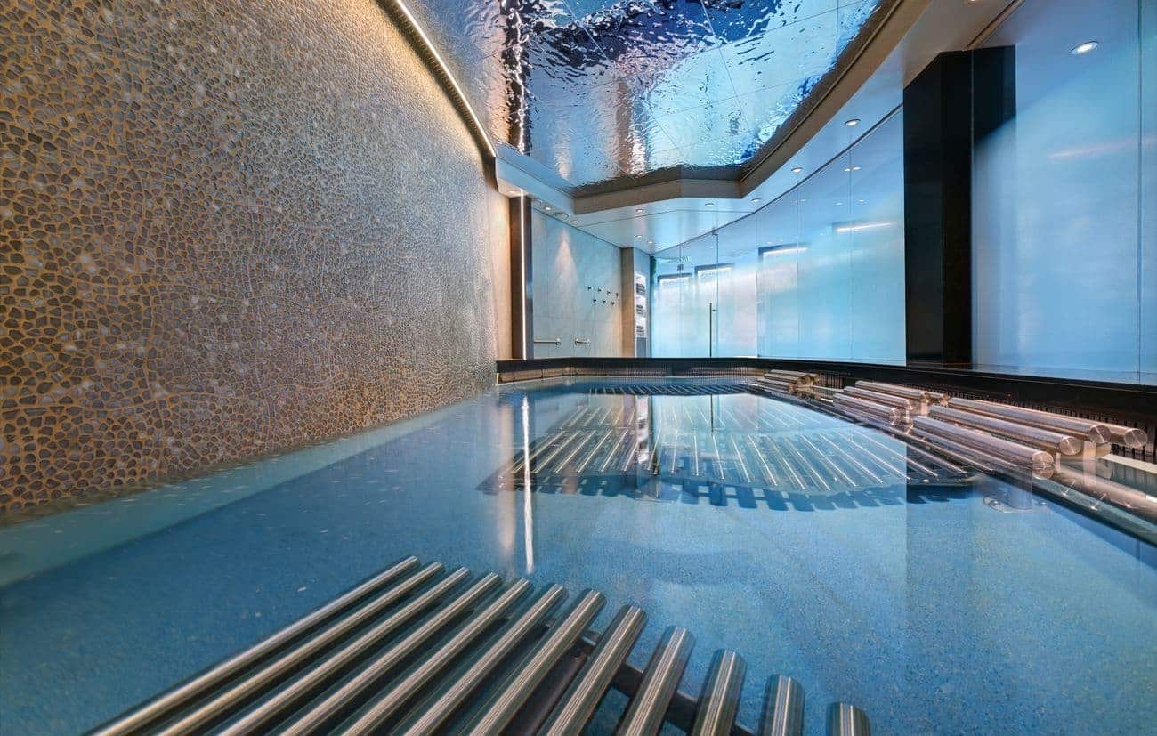 Hydrotherapy pool with heated loungers and mosaic wall