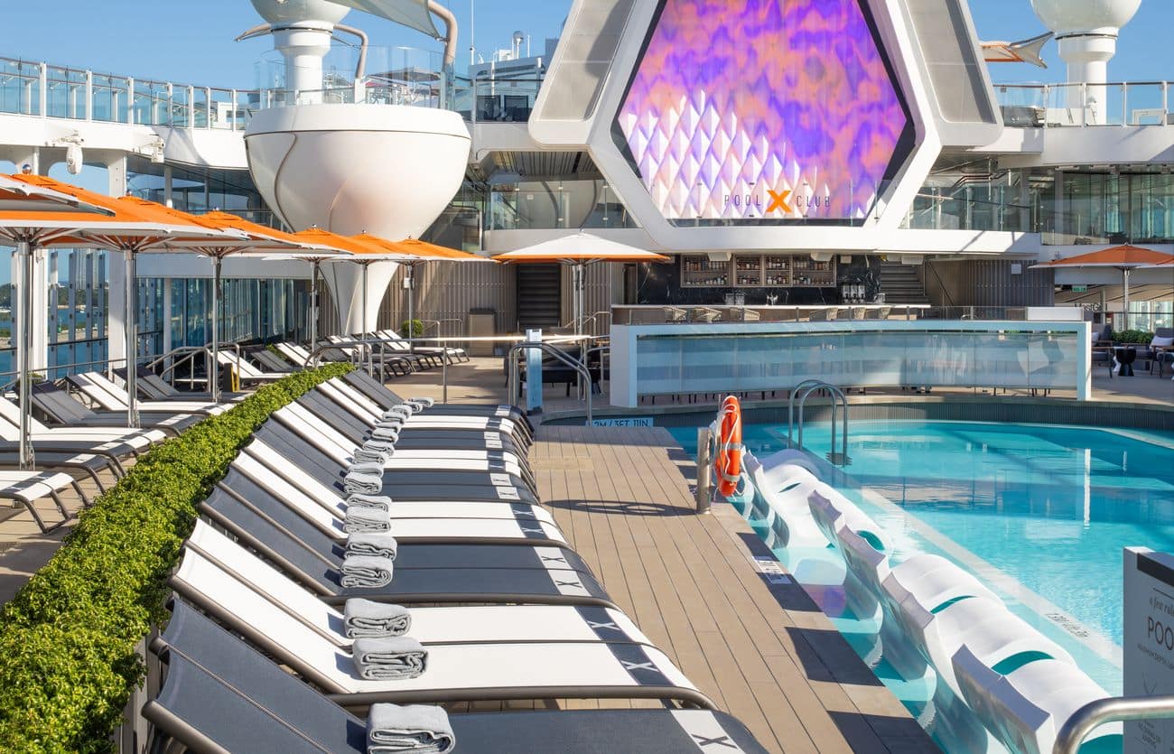 Resort-style pool deck with loungers and bar