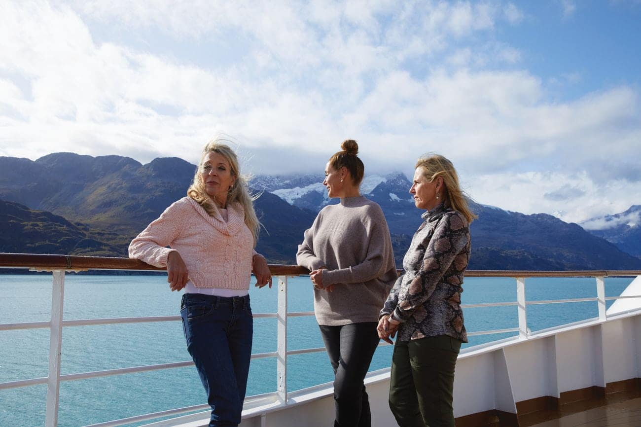 Guests enjoying scenic views on deck in Alaska
