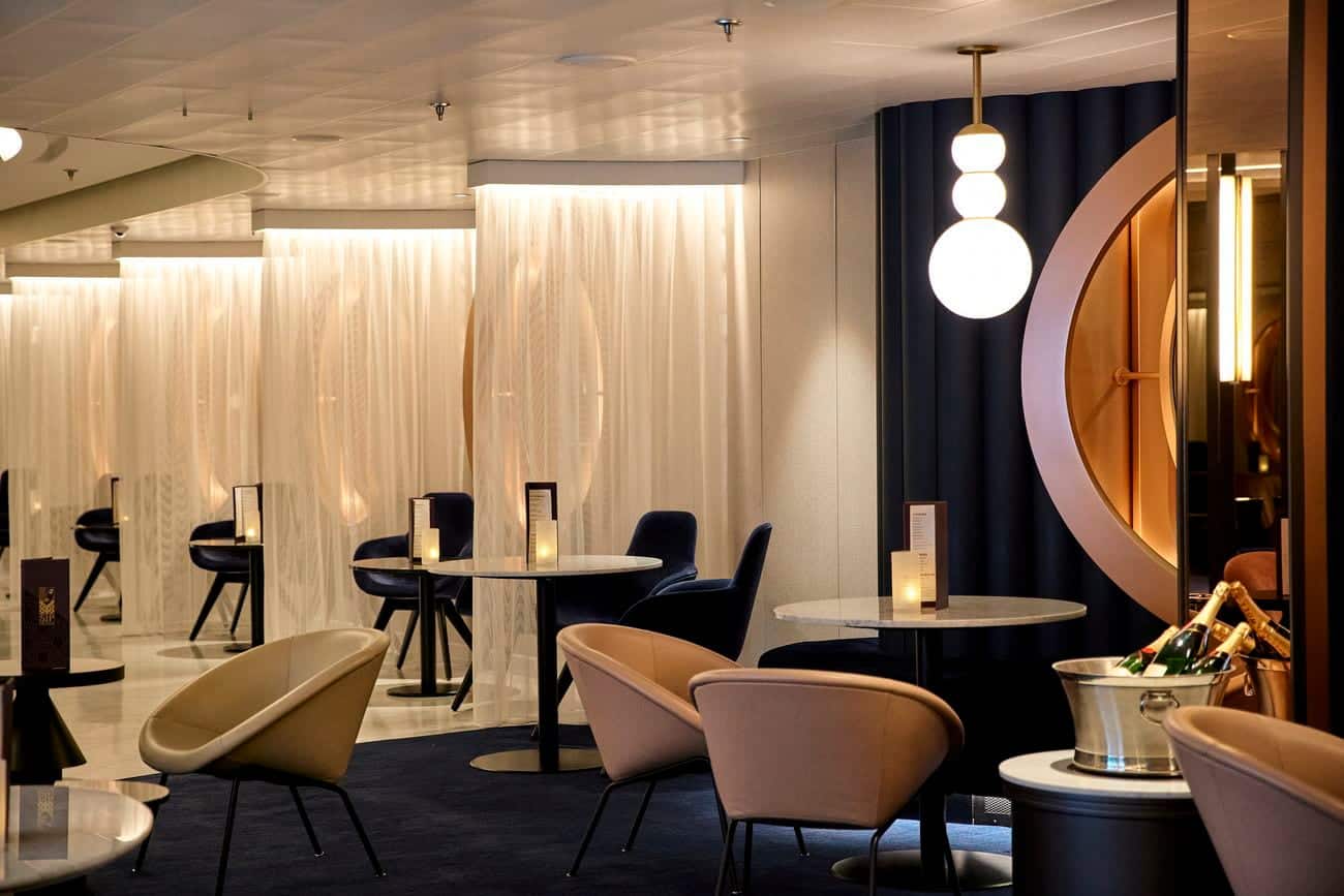 Sip Champagne Lounge aboard Brilliant Lady with modern seating and warm ambient lighting