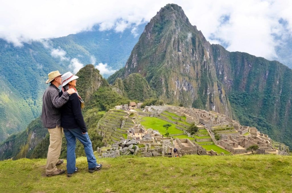 Travelers overlooking Machu Picchu ruins in Peru on South America cruise overland tour