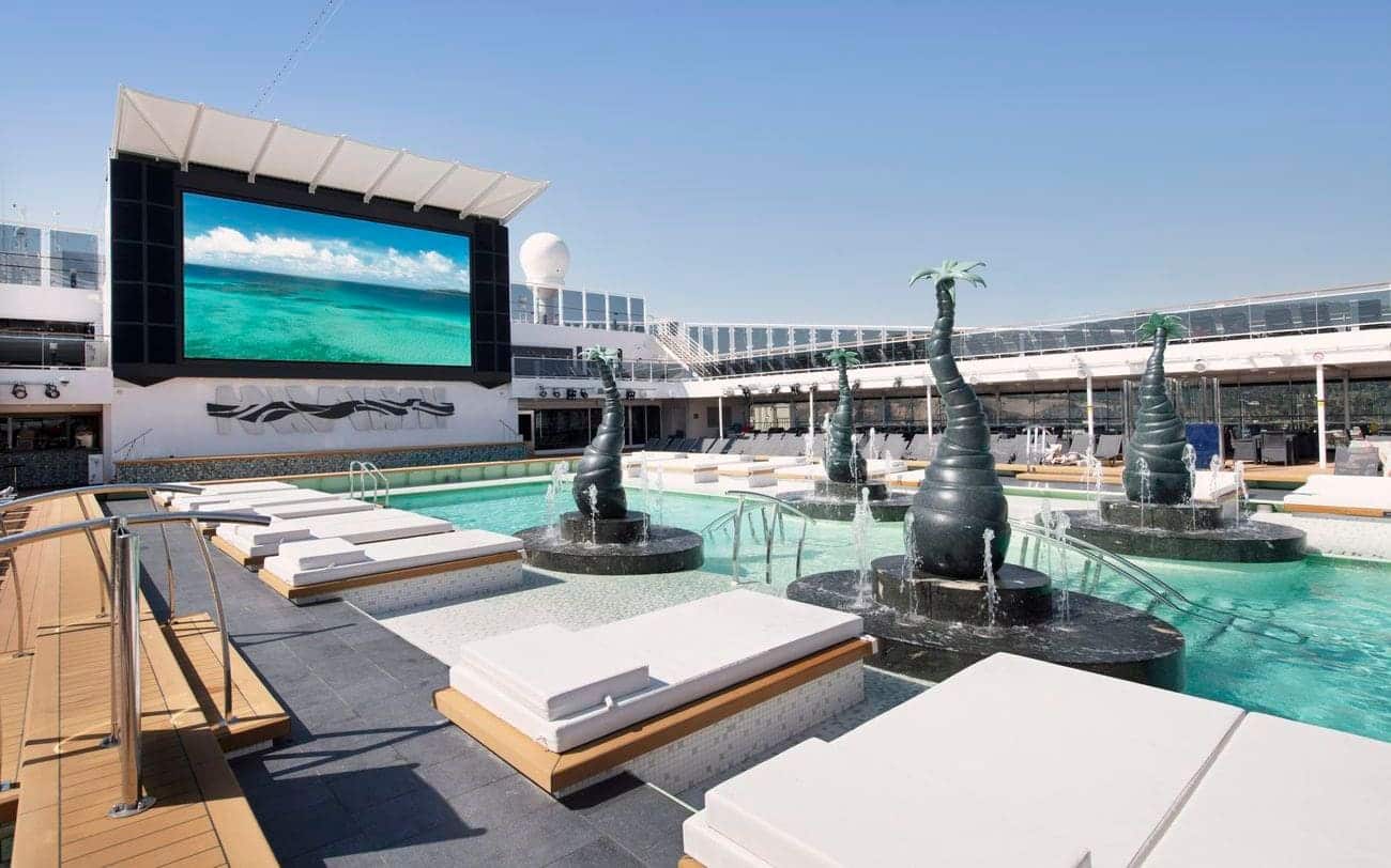 Open-air pool deck with loungers and water features