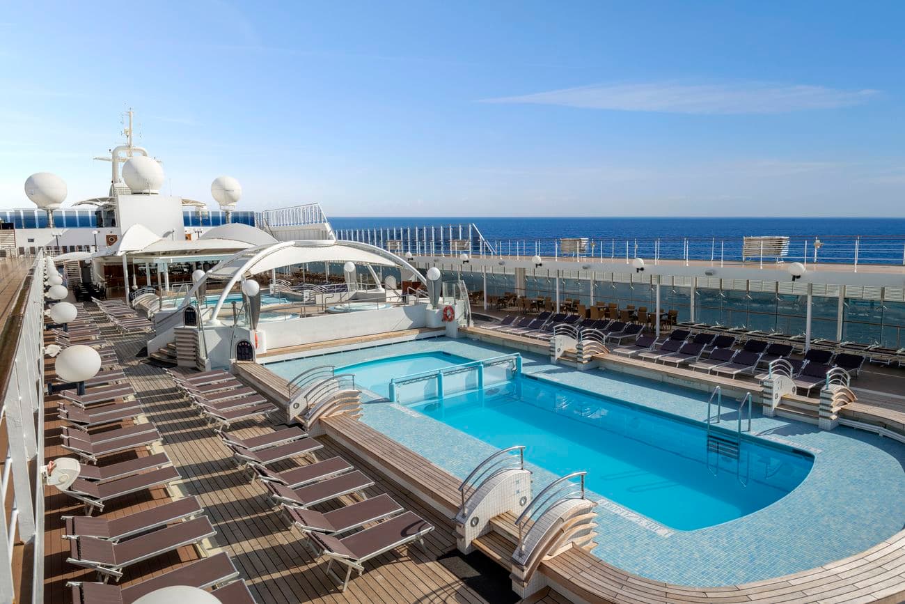 Open deck swimming pool with sun loungers
