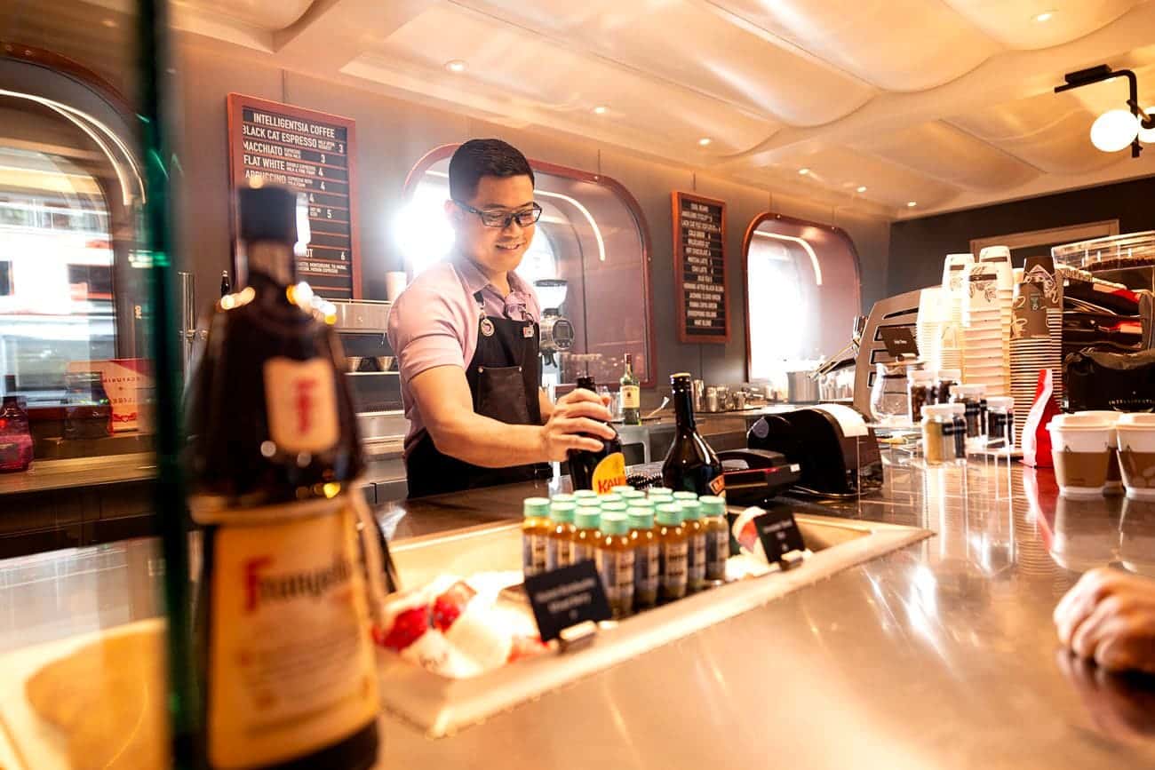 Grounds Club Too barista preparing specialty drinks onboard