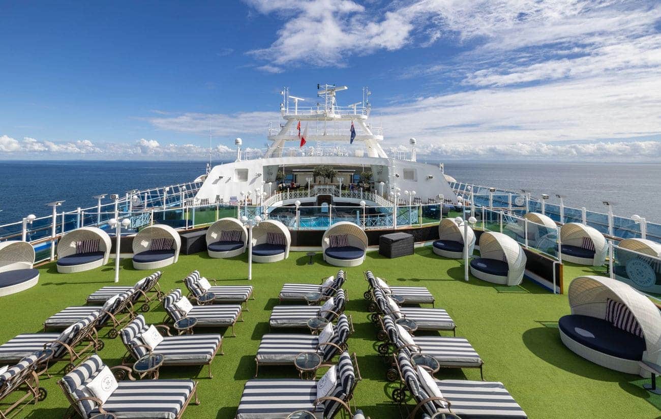 Carnival Adventure Byron Beach Club sun deck with loungers and shaded daybeds