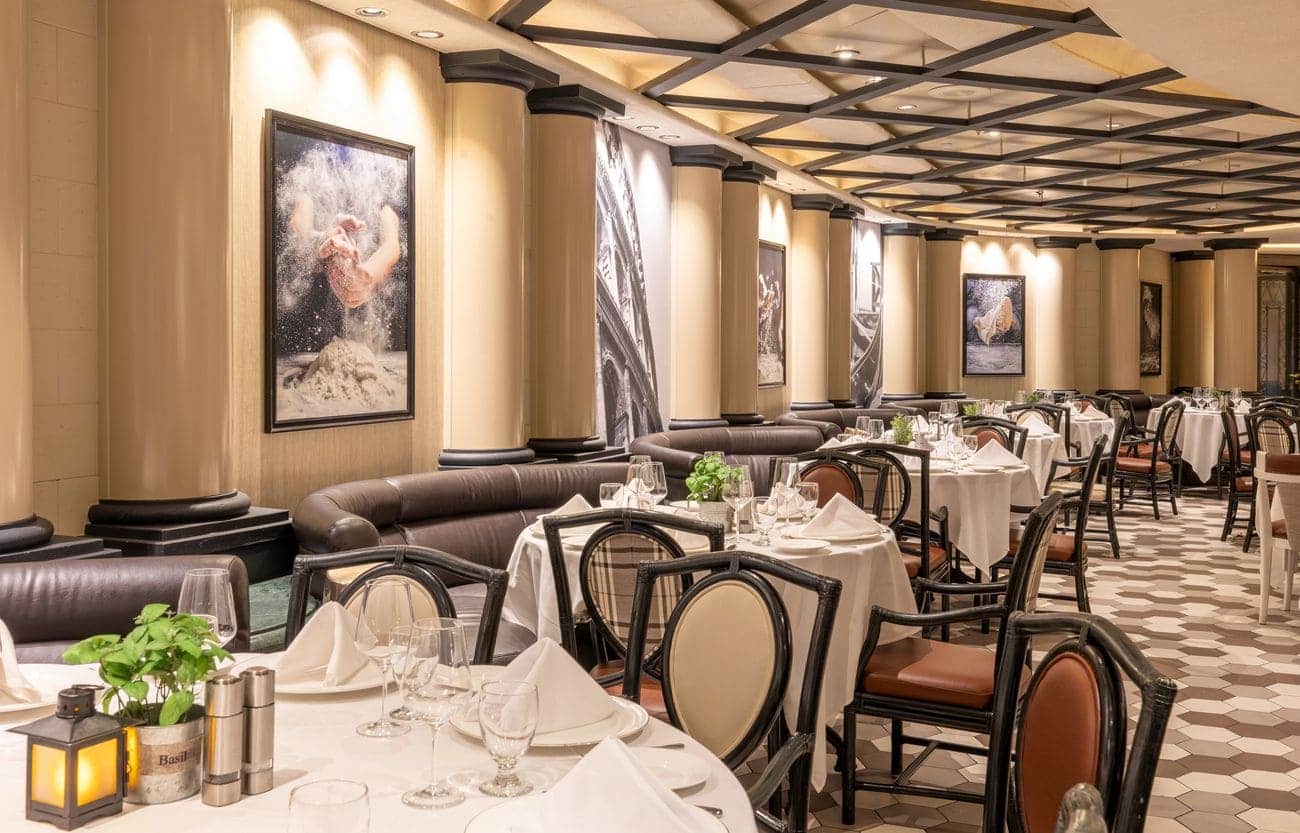 Trattoria restaurant with booth seating and softly lit tables