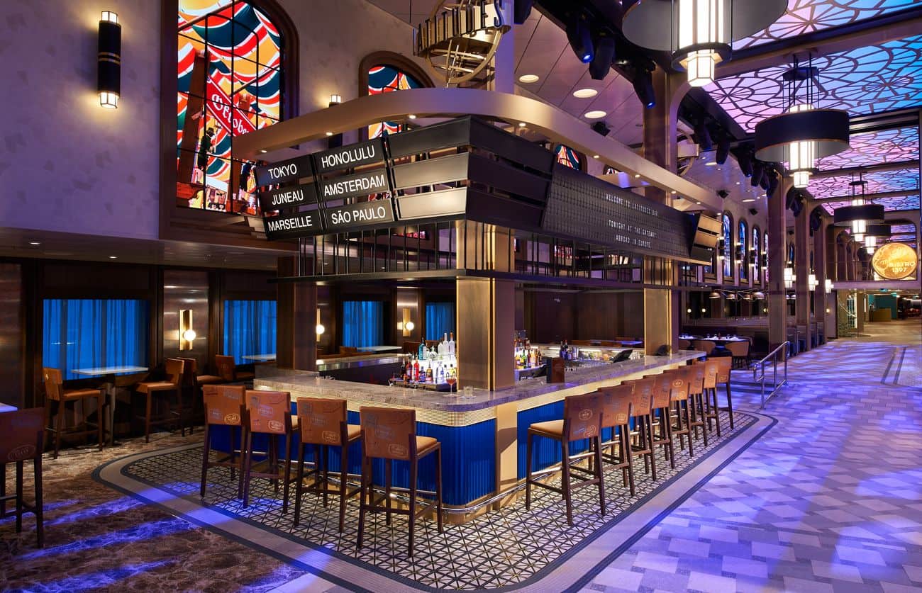 Latitudes bar lounge with destination-themed decor and illuminated counter