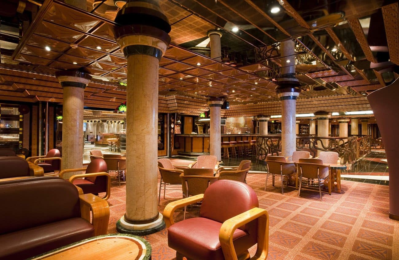 Multi-level interior promenade lounge with marble columns and seating