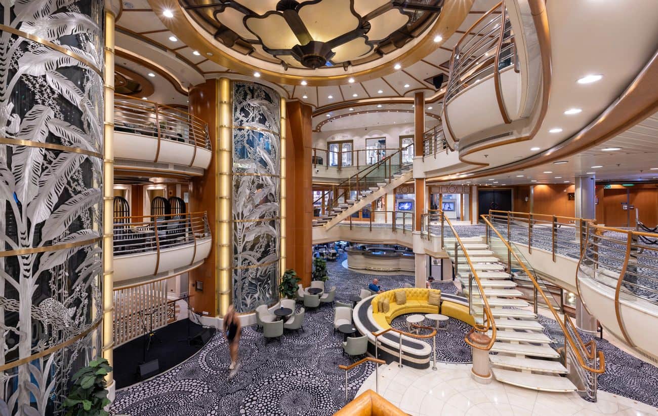 Carnival Encounter atrium with grand staircase and decorative glass panels