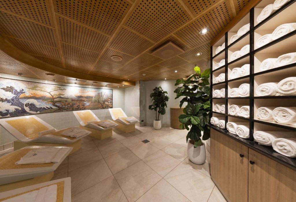 Cloud 9 Spa thermal suite with heated loungers, towel shelving, mosaic wall art and soft lighting