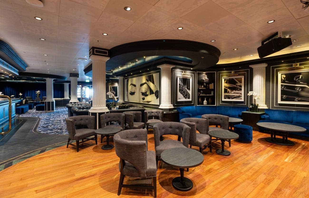 Piano bar lounge with blue seating and classic décor