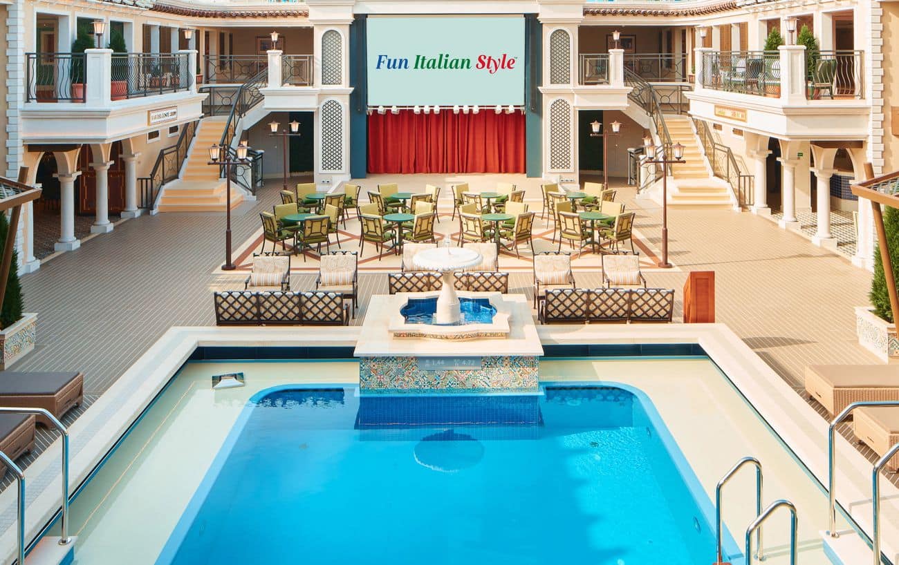 Italian-inspired Lido pool deck courtyard with fountain and stage on a cruise ship