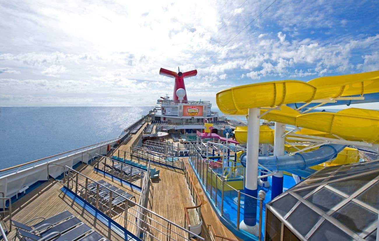 Carnival Glory WaterWorks water park with twisting yellow slides overlooking the open ocean