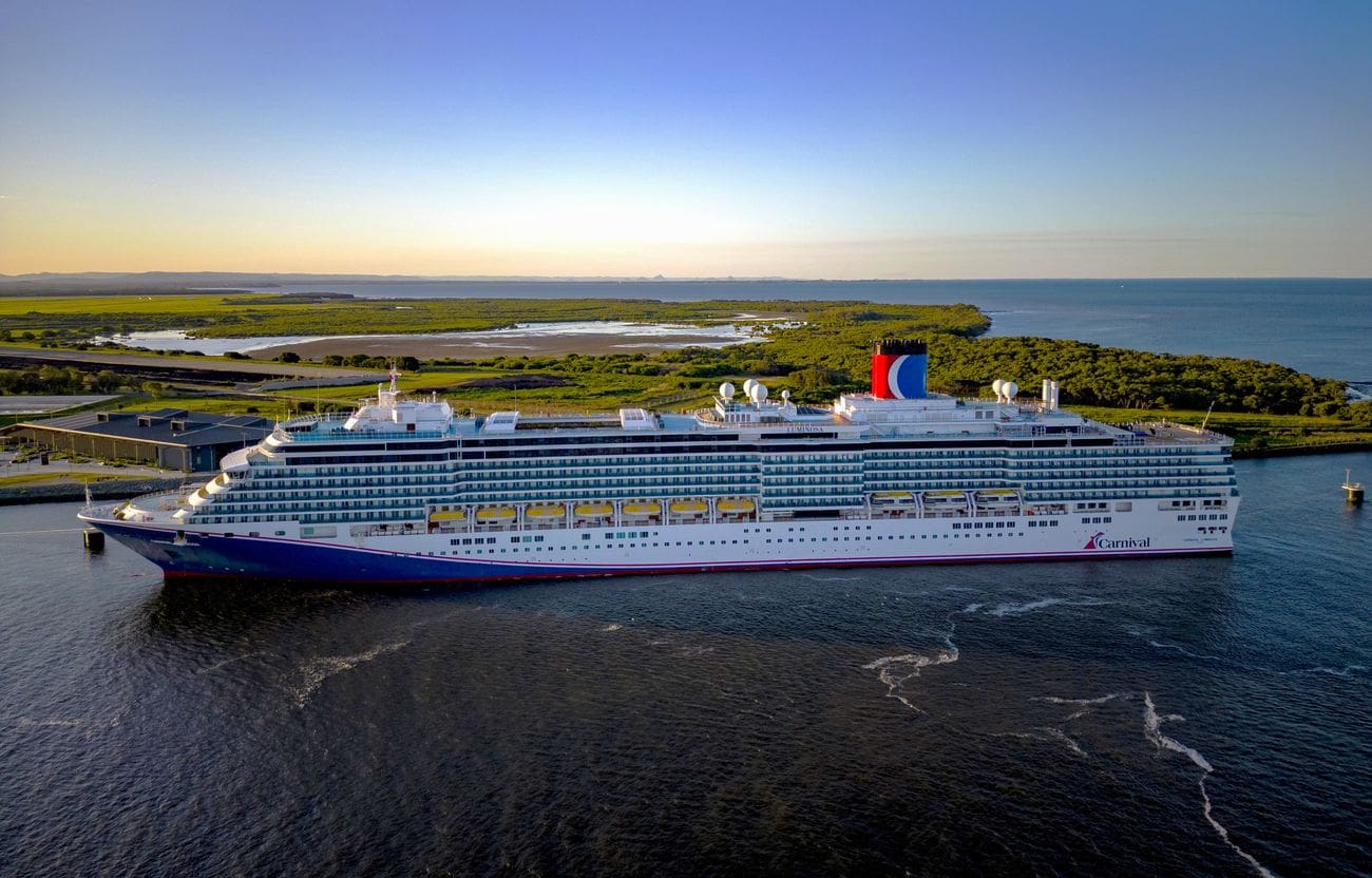 Carnival Luminosa docked near Brisbane coastline aerial view
