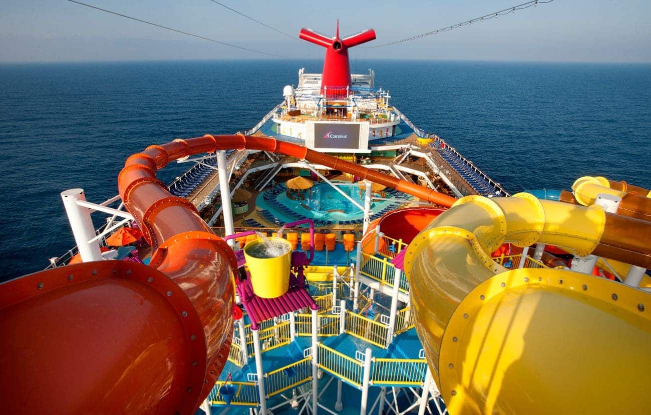 Carnival Magic WaterWorks water park slides with colorful tubes and splash zone overlooking the ocean